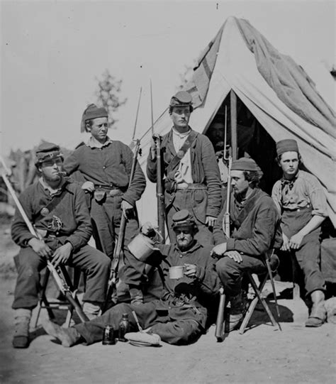 Union Zouaves of the 4th Michigan Volunteer Infantry Regiment posing in front of a tent in an ...