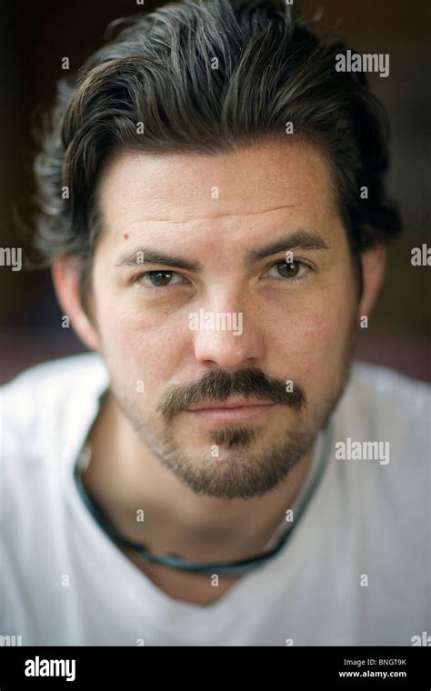 Portrait of man sitting in coffee shop Stock Photo - Alamy