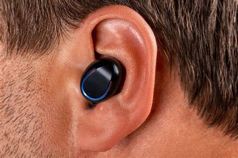 Black wireless earphone in a man's ear - Creative Commons Bilder