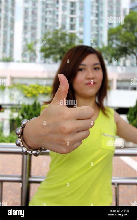 Asian woman with thumbs up Stock Photo - Alamy