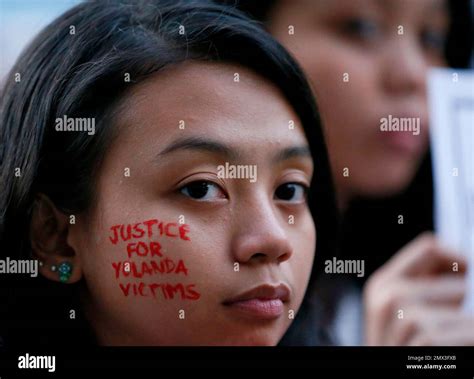 A student from the University of the Philippines has her cheek scribbled with a message in ...