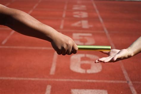 Premium Photo | Relay race baton exchange