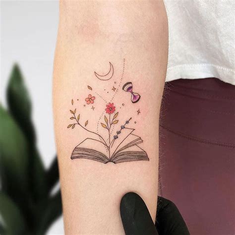 a woman's arm with a book and flowers tattoo on the left side of her arm