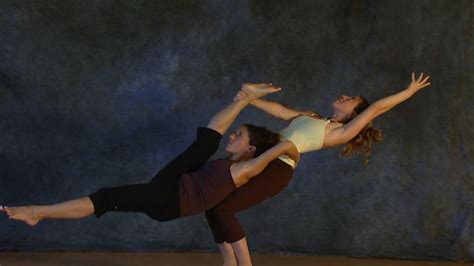 two women are performing an acrobatic dance