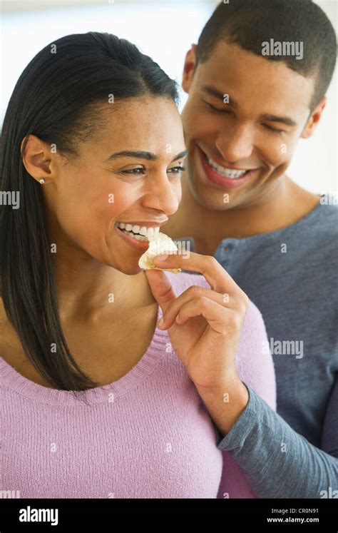 USA, New Jersey, Jersey City, Couple eating potato chips Stock Photo - Alamy