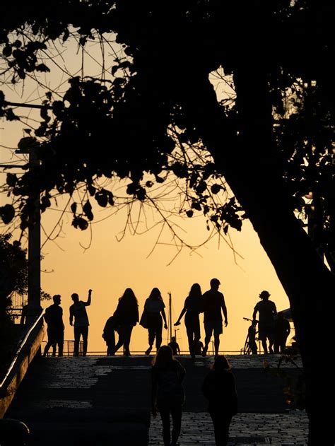 silhouette of people walking on sidewalk during sunset photo – Free Tel aviv Image on Unsplash