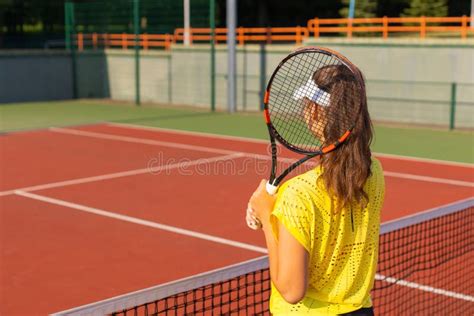 Back View of Beautiful Tennis Player Ready To Serving the Ball on the Tennis Court. Stock Photo ...