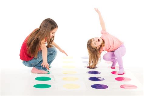 Premium Photo | Two happy girls play twister game