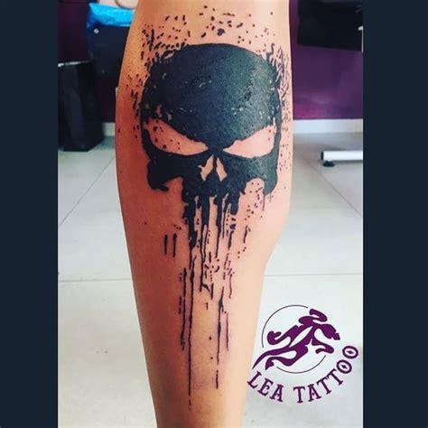 a person with a black and white tattoo on their leg that has a skull painted on it