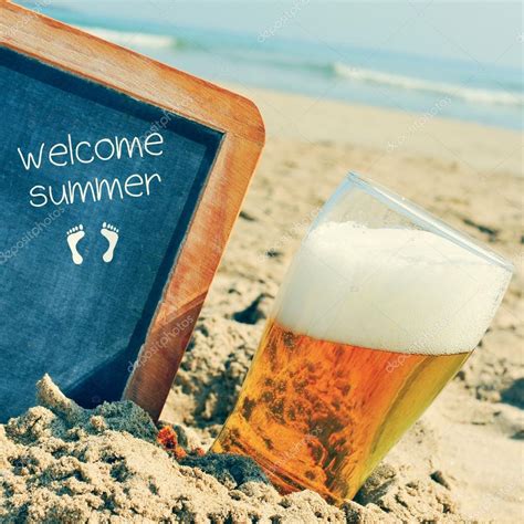 Welcome summer chalkboard | Beer and chalkboard with the text welcome summer, on the sand of ...