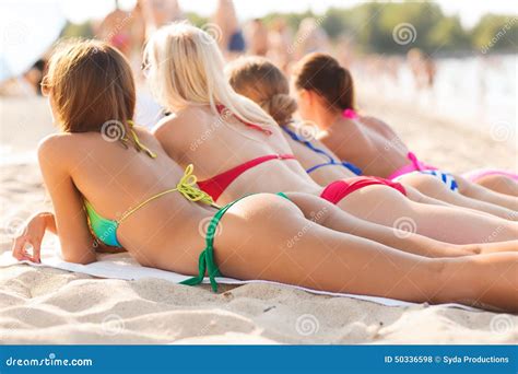 Close Up of Young Women Lying on Beach Stock Photo - Image of cellulite ...