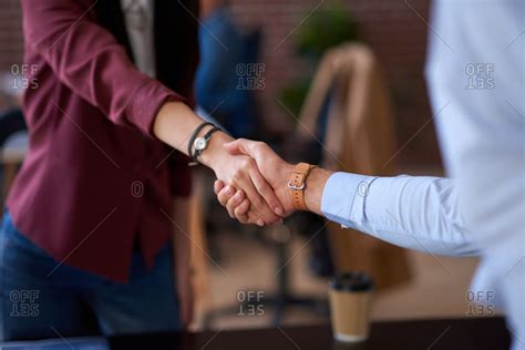 Business people shaking hands in office meeting after successful partnership deal for startup ...