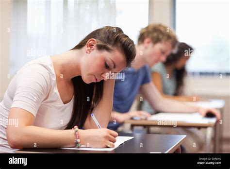 Studious woman writing Stock Photo - Alamy