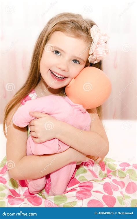 Adorable Smiling Little Girl Playing with a Doll Stock Photo - Image of smile, expression: 40043870