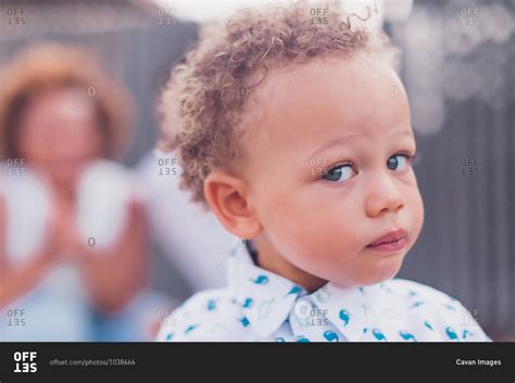 Mixed race baby boy with blue eyes looking at camera stock photo - OFFSET