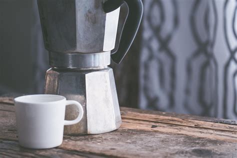 White Ceramic Cup Beside Stainless Steel Kettle on Brown Wooden Table · Free Stock Photo