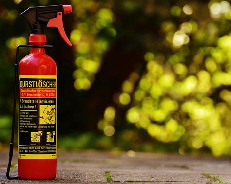 Red Fire Extinguisher Beside Hose Reel Inside the Room · Free Stock Photo