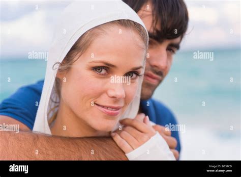 Couple smiling on the beach Stock Photo - Alamy