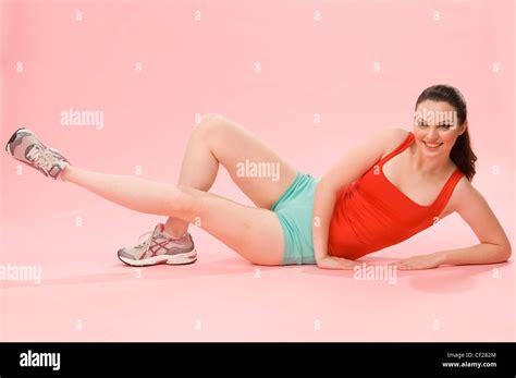 Female lying down doing leg raises Stock Photo - Alamy
