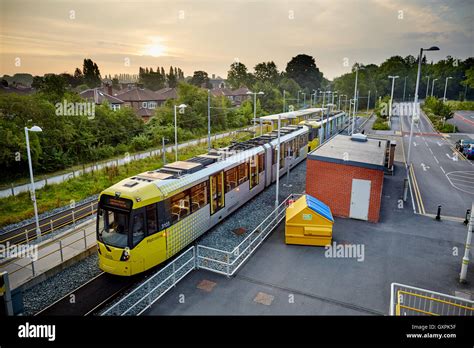 East Didsbury tram station stop tram morning sunrise looking into ...