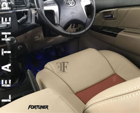 the interior of a car with tan leather seats and steering wheel controls, including center console