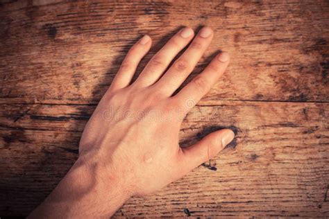 Man hand lay on the table. stock photo. Image of guilt - 87398900