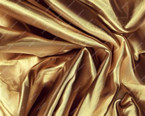 Premium Photo | Gold fabric texture background crumpled fabric background