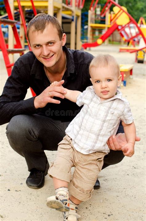 Toddler Boy with His Daddy Outdoors Stock Image - Image of smiling, fingers: 61738611