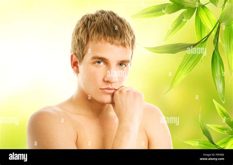 Handsome man over green abstract background Stock Photo - Alamy