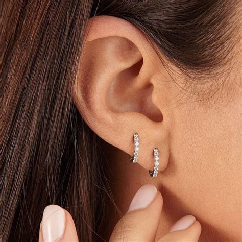 LILY & ROO's beautiful sterling silver diamond style huggie hoop earrings are designed to hug ...
