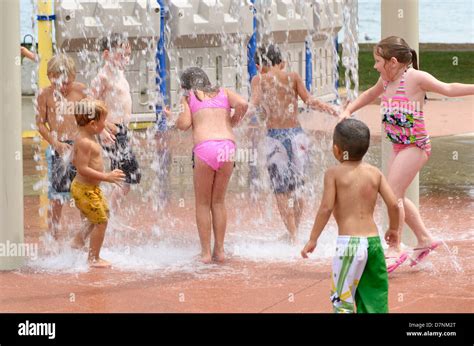 Group of children playing at splash pad in a park Stock Photo - Alamy