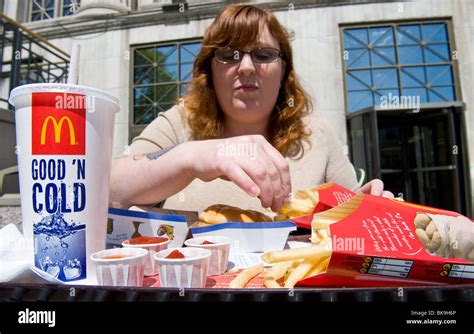 Overweight woman eating McDonald's fast food meal Stock Photo - Alamy
