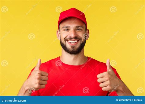 Close-up of Friendly Smiling Delivery Guy in Red Uniform Cap and T-shirt Provide Best Express ...