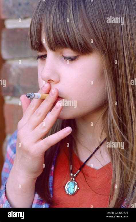 young teenager starting to smoke, smoking a cigarette, cigaret Stock Photo - Alamy