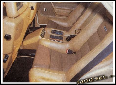 the interior of a car with tan leather seats and dashboards, including electronic controls