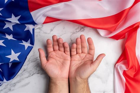 Premium Photo | Two open hands surrounded by the flag of the United States of America Freedom ...