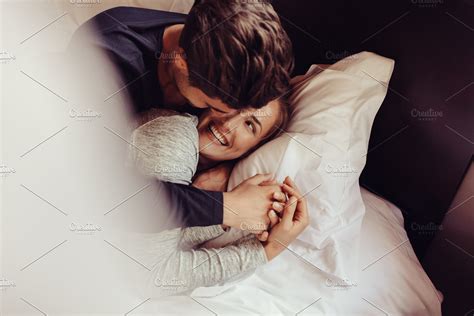 Romantic couple in love lying on bed | High-Quality People Images ...