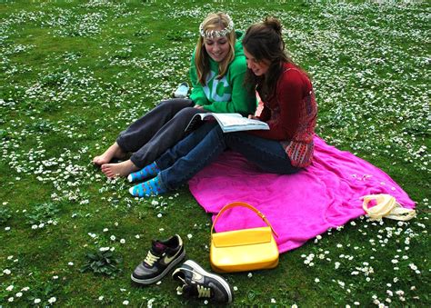 On a pink, green, and white cloud, two young women reading… | Flickr