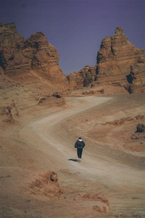 Hiker on Path through Rugged Mountains · Free Stock Photo