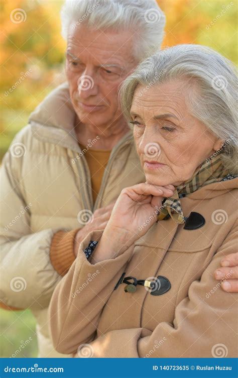 Portrait of Sad Senior Couple in Autumn Park Stock Image - Image of ...