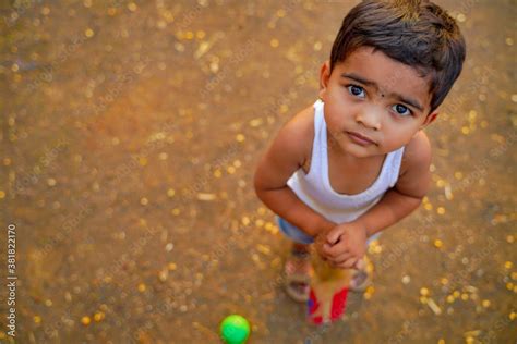 small indian child playing cricket at home Stock Photo | Adobe Stock