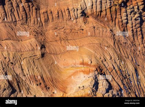 From above rough textured surface of sandstone cliff with cracks and ...