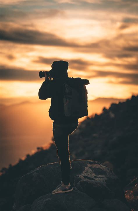 Download Silhouette Of Man Holding Camera During Sunset Photography Wallpaper | Wallpapers.com