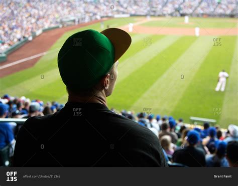 Man watching a baseball game at a stadium stock photo - OFFSET