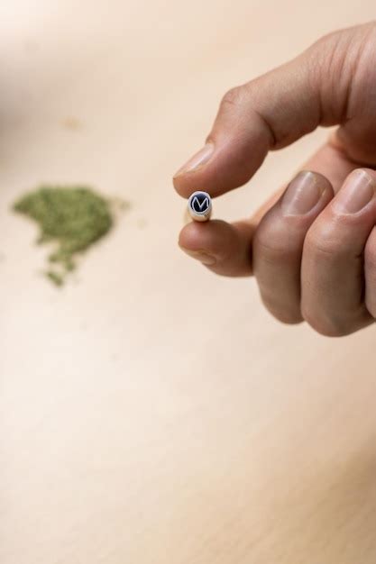 Premium Photo | A person39s hand holding a filter to assemble a marijuana joint