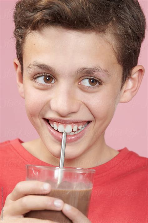 "Cheerful Kid Drinking Chocolate Milk" by Stocksy Contributor "Guille Faingold" - Stocksy