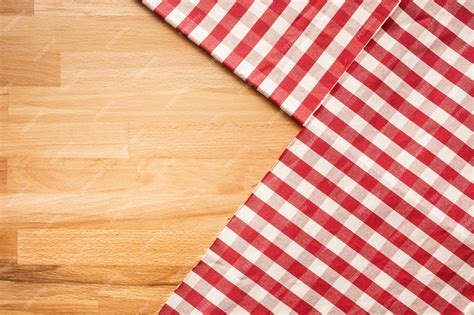 Premium Photo | Red checkered fabric on wood table background.for ...