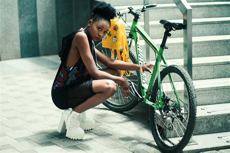 Woman Wearing Black Dress Seating Near Green Bicycle · Free Stock Photo