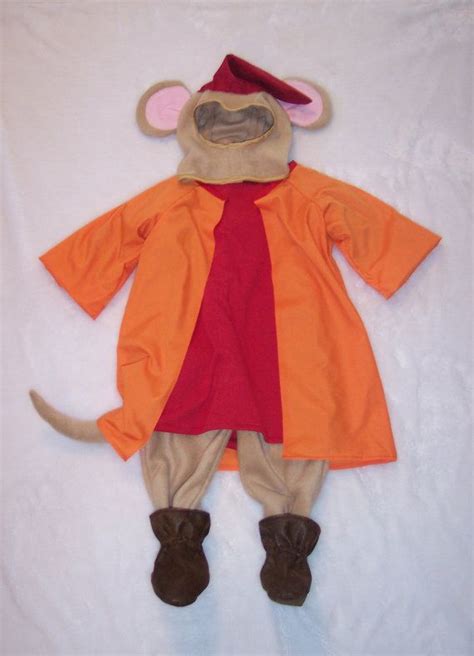 a stuffed animal dressed in an orange and red outfit