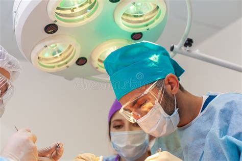 Baldness Treatment. Hair Transplant. Surgeons in the Operating Room Carry Out Hair Transplant ...